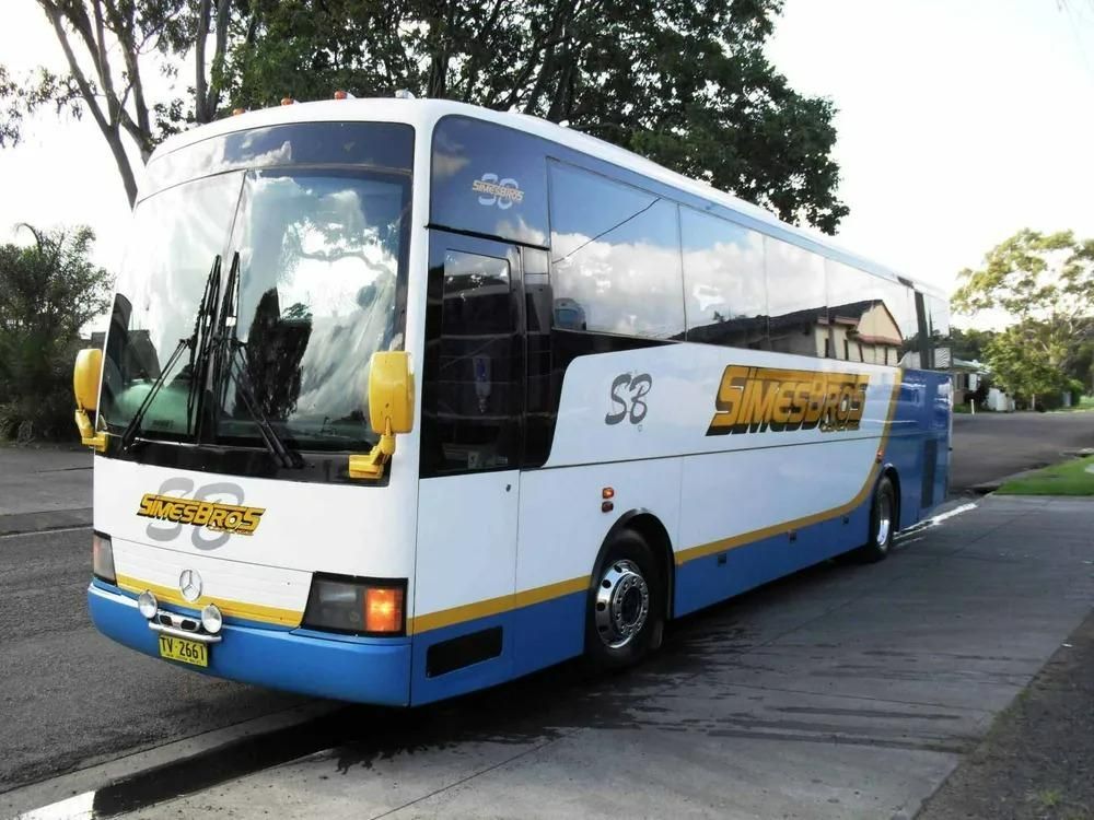 A Blue and White Bus with The SB on It — Simes Bros Coaches in Grafton, NSW