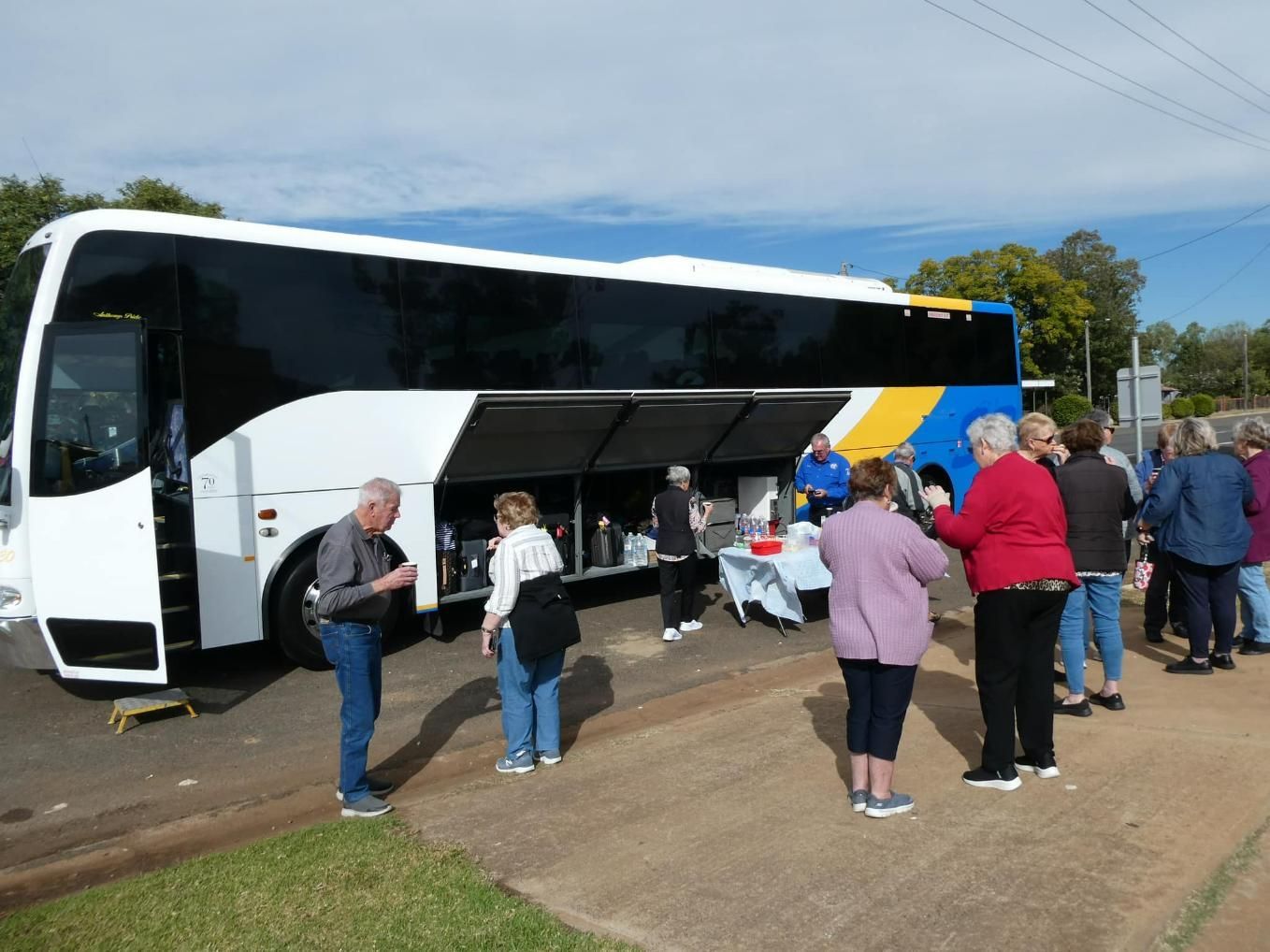 A Group of People Standing in Front of A Bus — Simes Bros Coaches in South Lismore, NSW