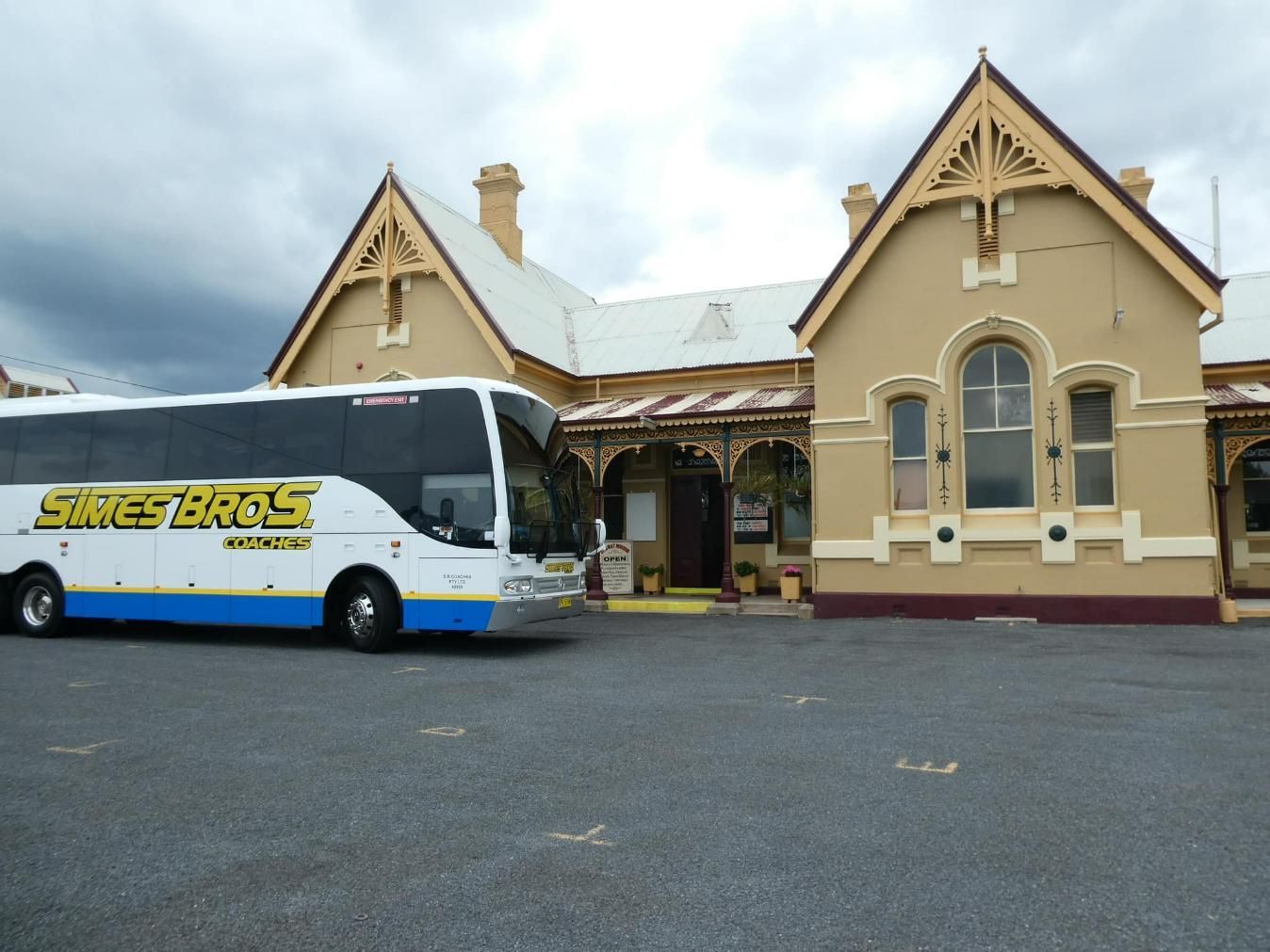 A Strike Bros Bus Is Parked in Front of A Building — Simes Bros Coaches in South Lismore, NSW