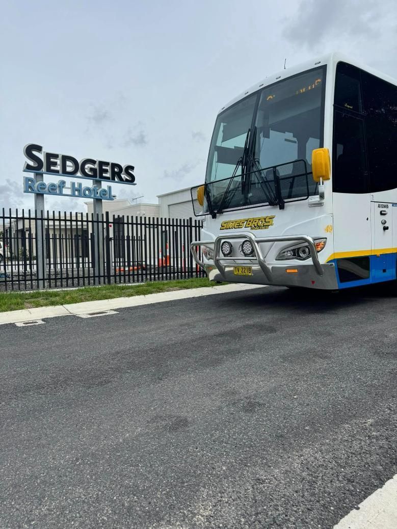 A Bus Is Parked in Front of A Building that Says Sedgers — Simes Bros Coaches in South Lismore, NSW