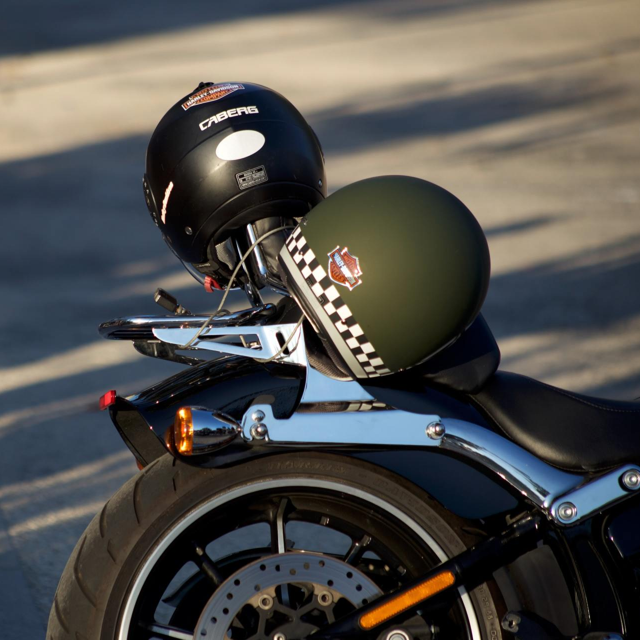 Motorcycle helmets placed on the back of a motorcycle
