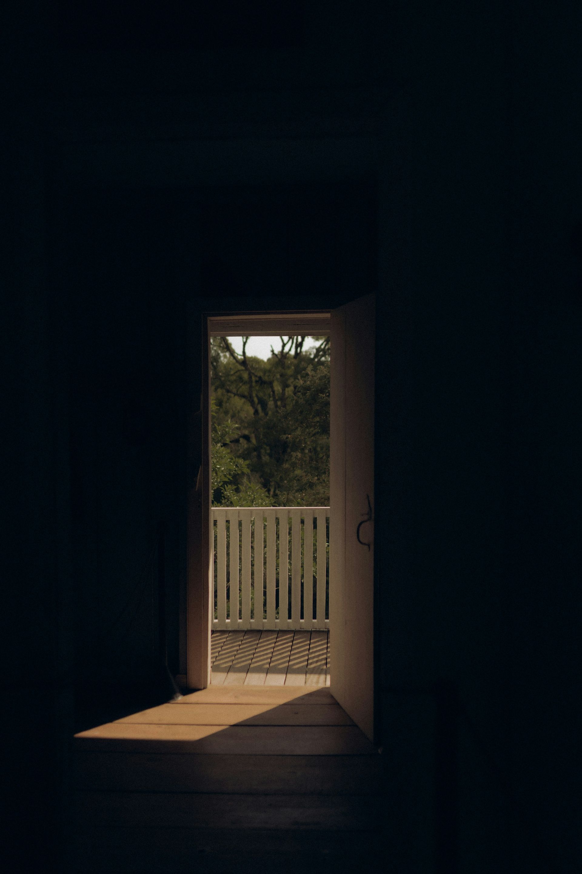 Open doorway with sunlight leading outside.