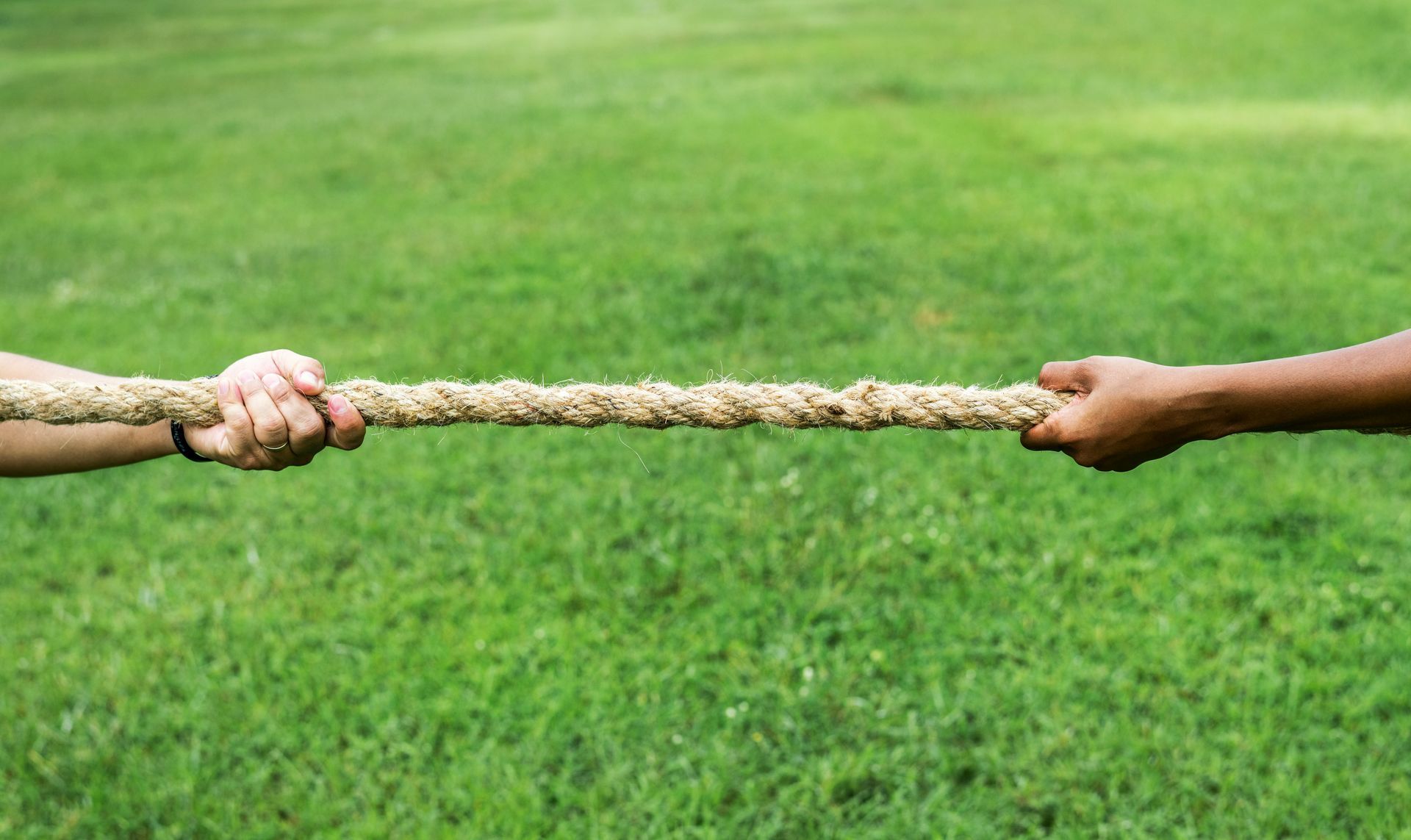 Two people pulling on opposite ends of a rope, representing the emotional push-and-pull of trauma bonding.