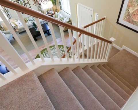View down interior carpeted stairs in a modern American home.