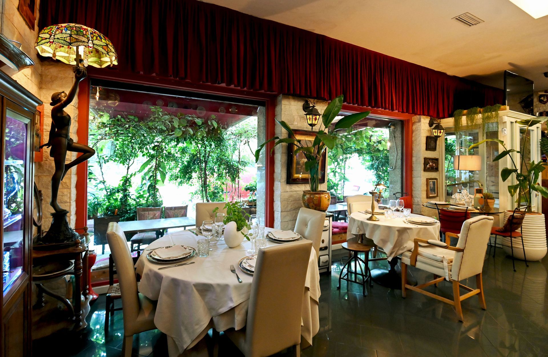 Una sala da pranzo con tavoli e sedie e una lampada