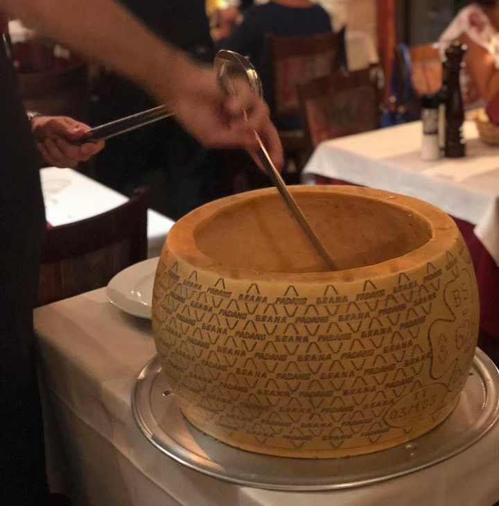 preparazione di un piatto dentro forma di Grana Padano