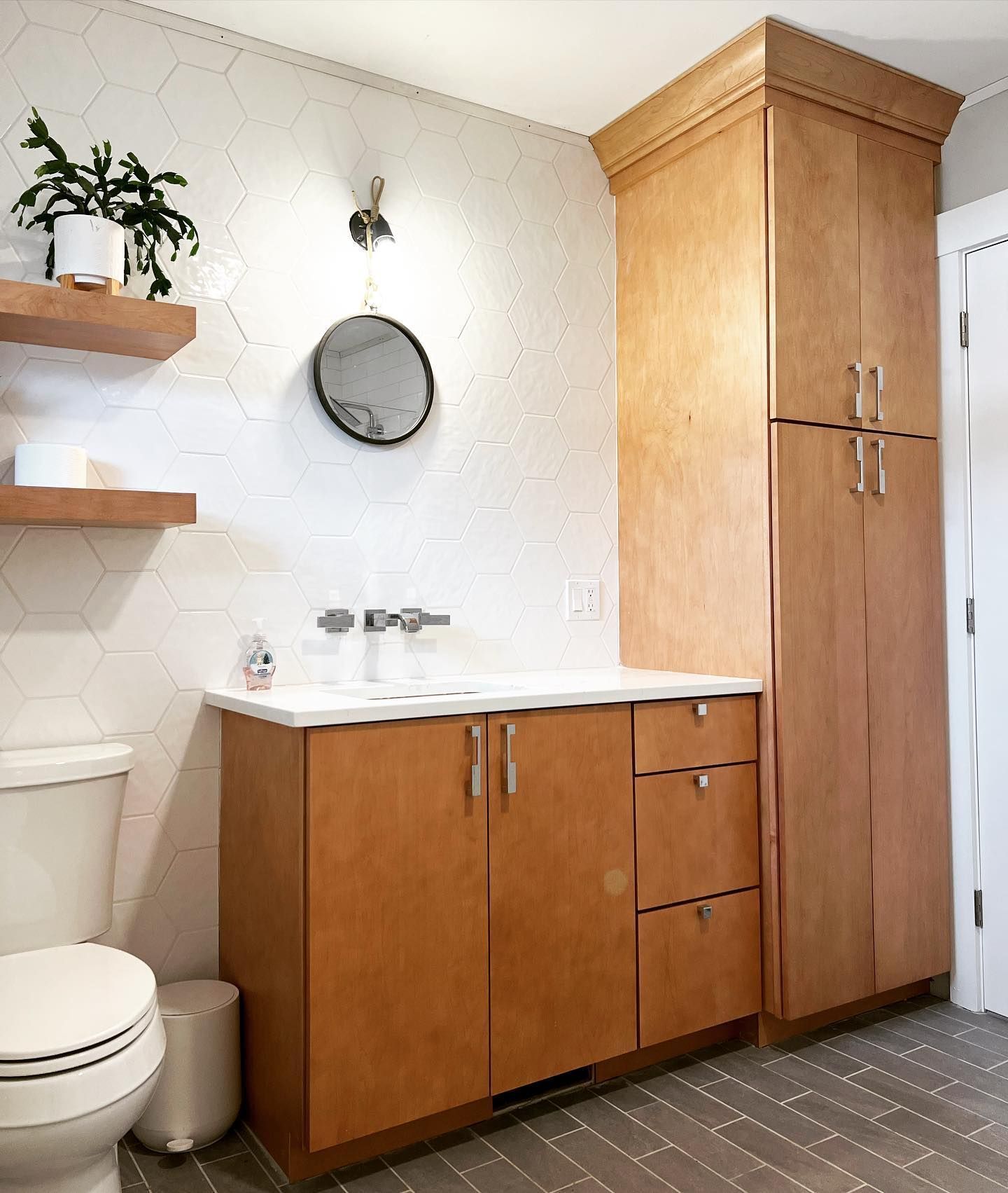 A bathroom with wooden cabinets and a toilet
