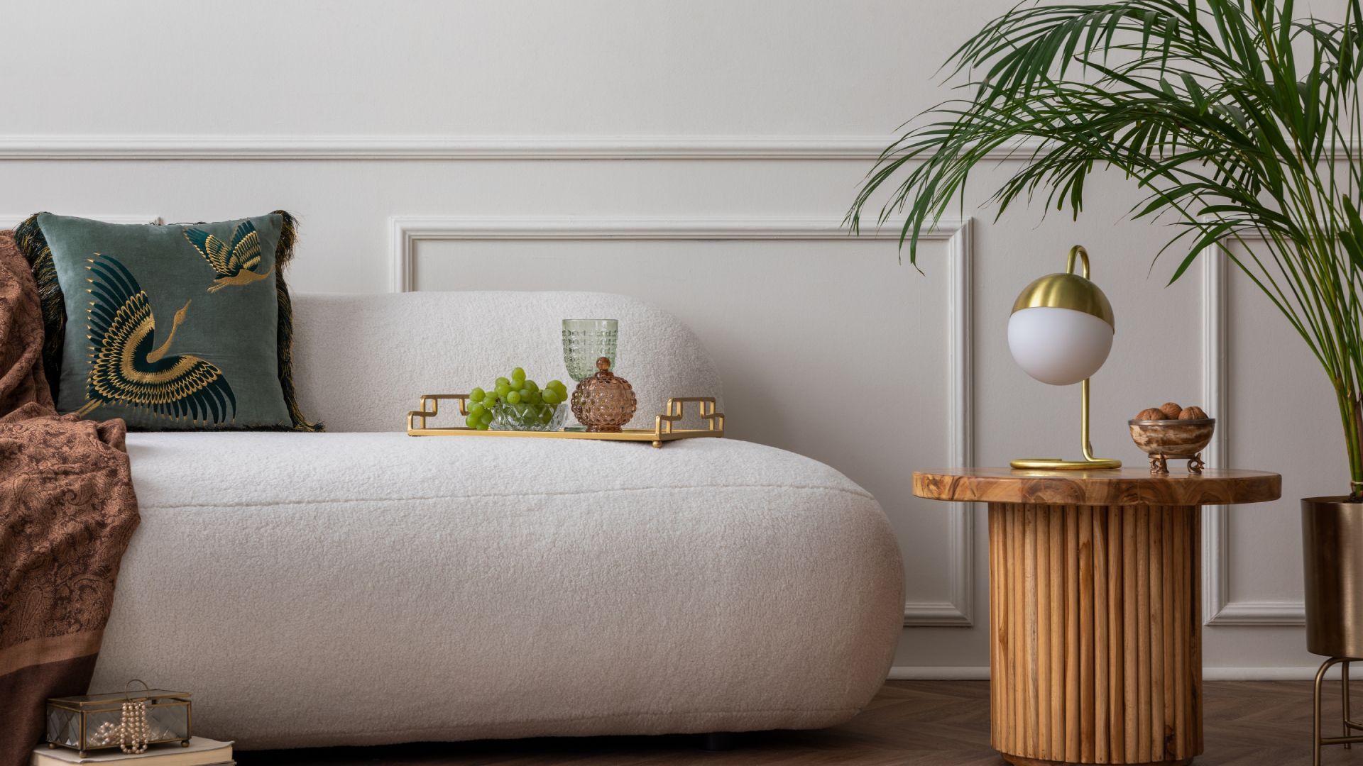 A living room with a white couch and a wooden table.