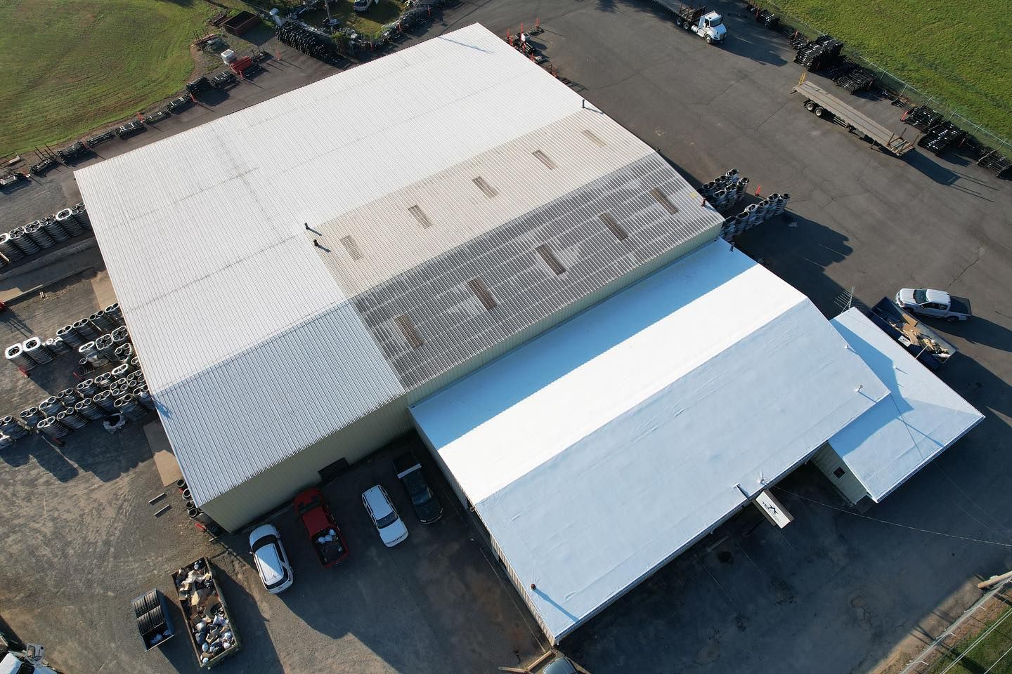 An aerial view of a large building with cars parked in front of it