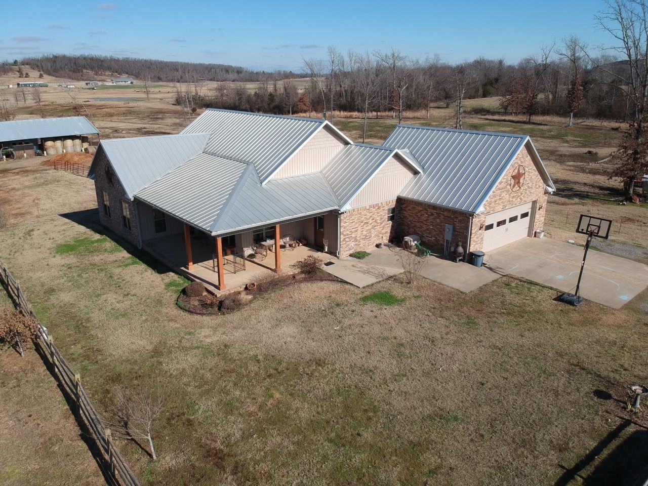An aerial view of a house with a metal roof