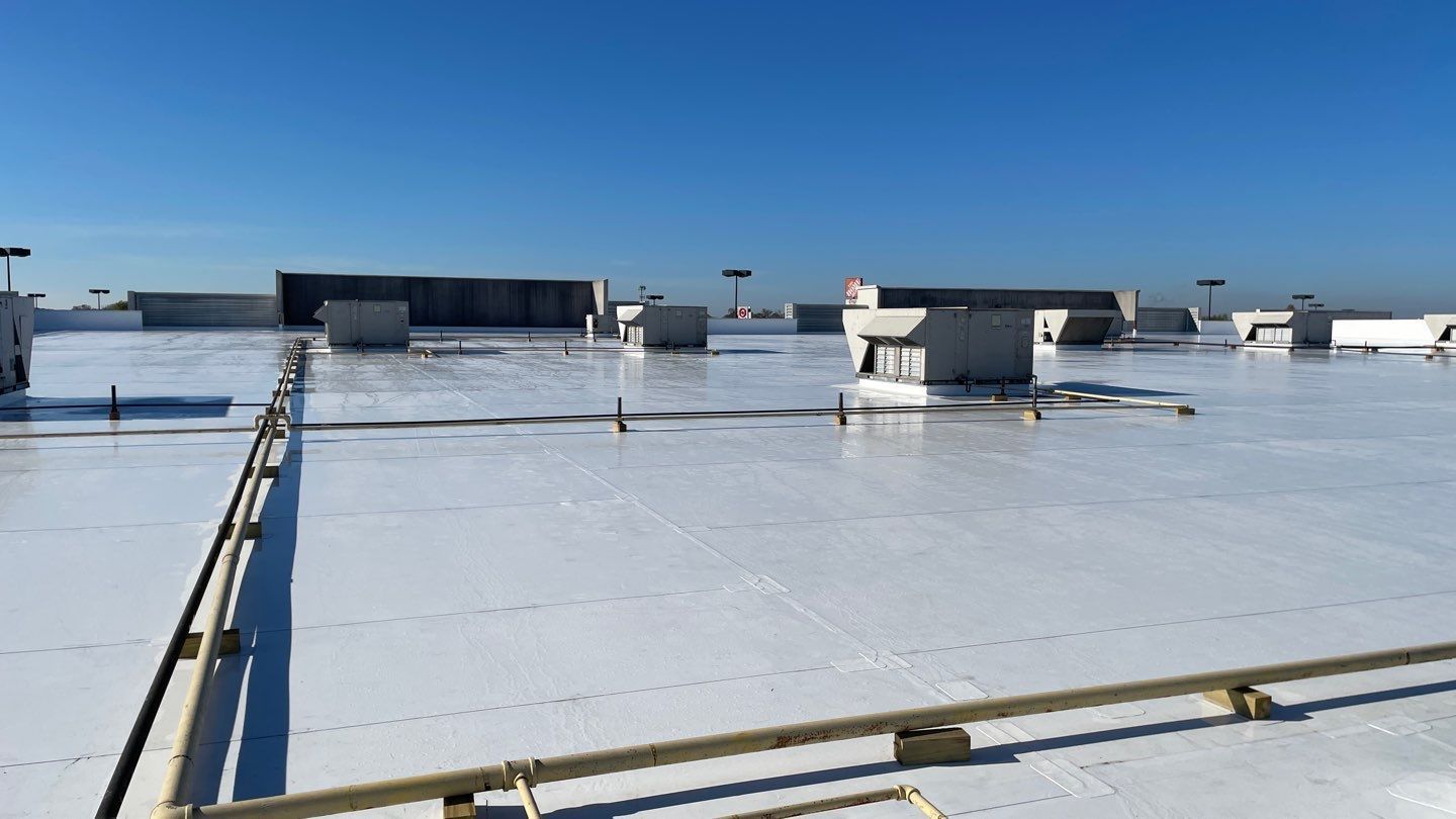 A large white roof with a blue sky in the background.