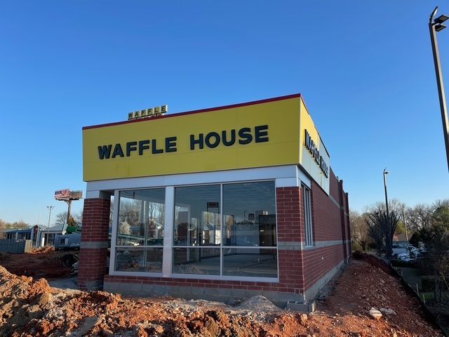 A waffle house is being built in a brick building