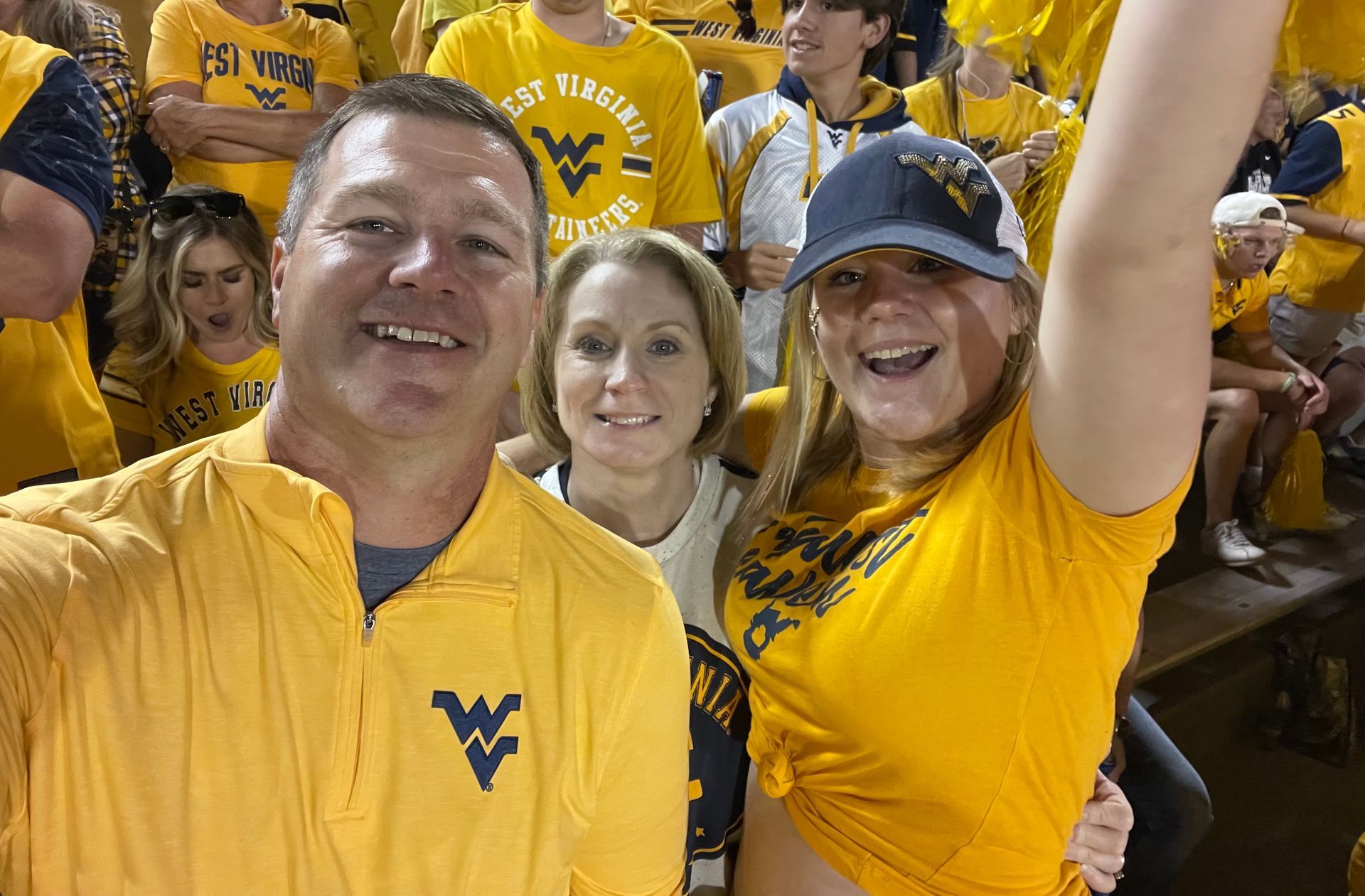 Jason Harshbarger with wife and daughter and West Virginia game