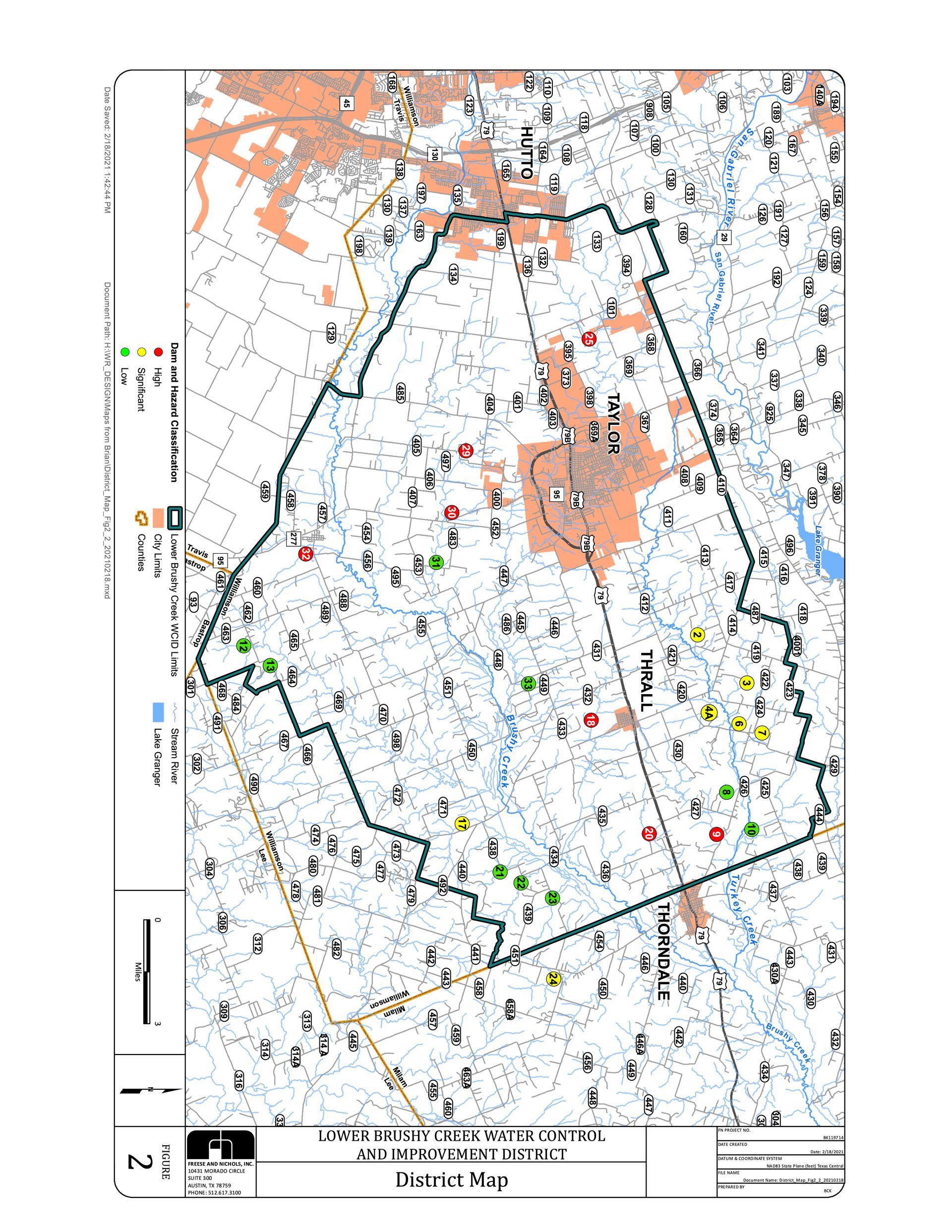 Topographic map of a county with a central town, delineated by a thick green border, containing various colored markers.