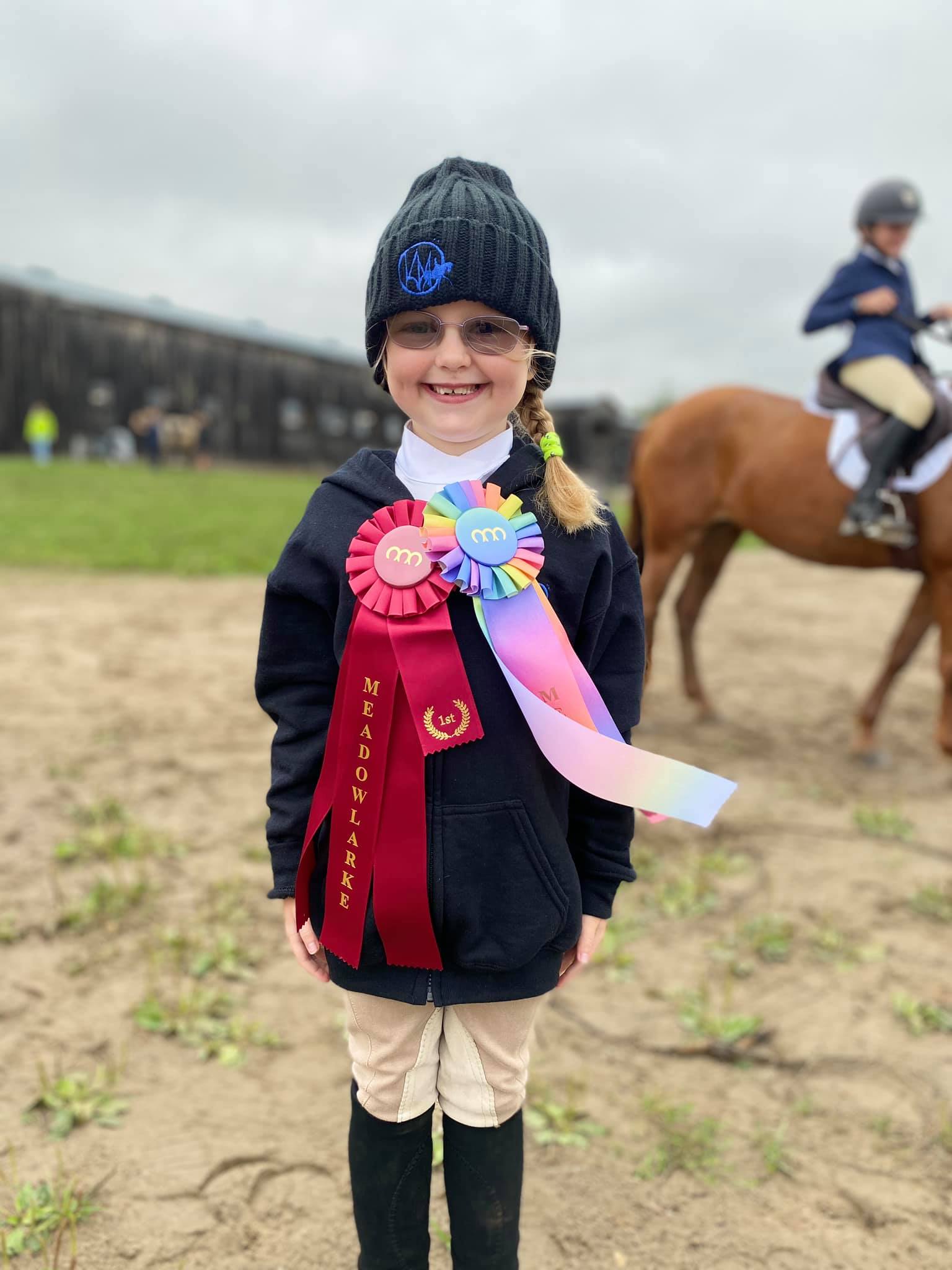 Young rider with winning ribbons
