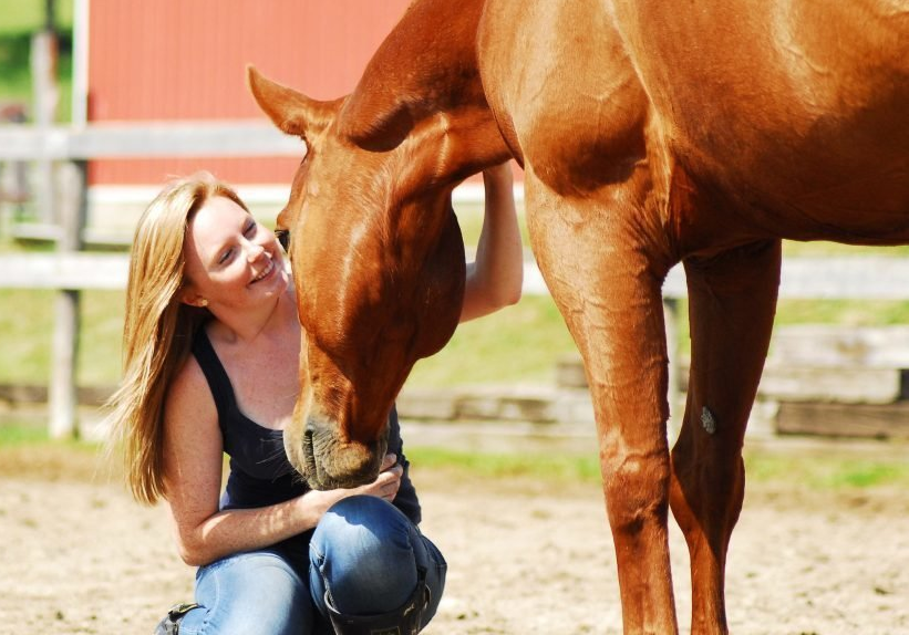 The Heart Horse blogger Emilie gives her horse a treat in Kings Meadow's outdoor sand ring.