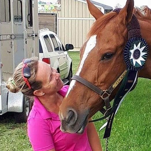 Horse owner, and owner of Kings Meadow, and her horse after winning a ribbon at a horse show