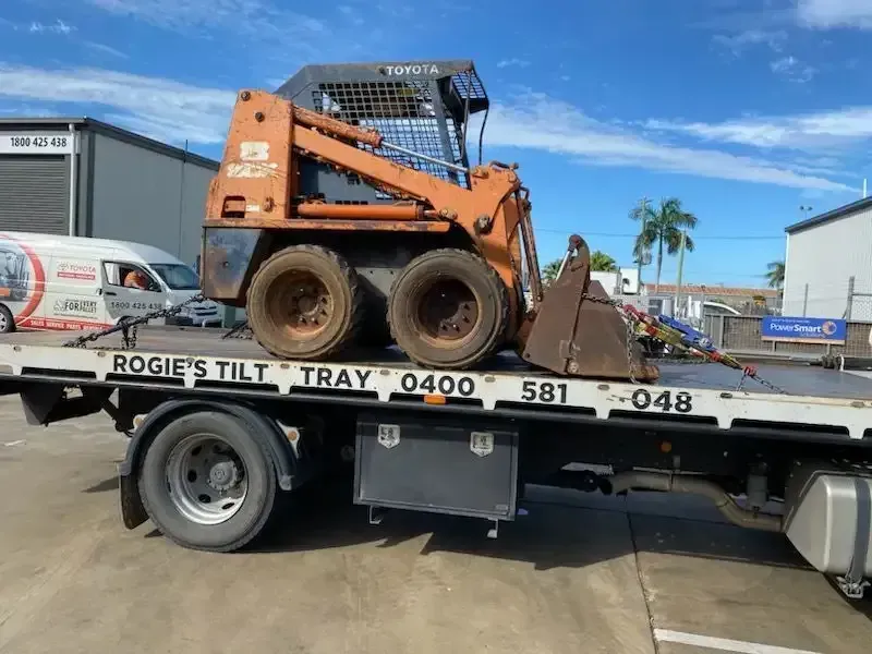 Orange Toyota Skid Steer on A Tilt Tray Truck, Outdoors — Sundance Auto & Machinery Pty Ltd In Airlie Beach, QLD 