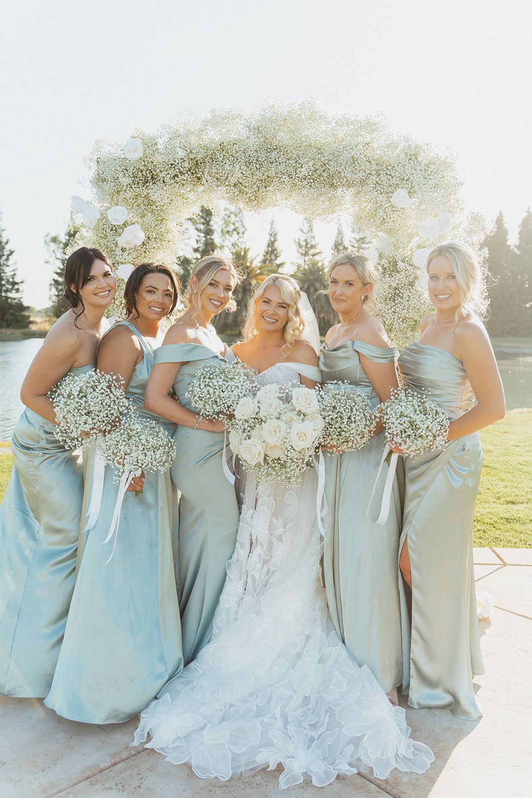 A bride and her bridesmaids are posing for a picture.