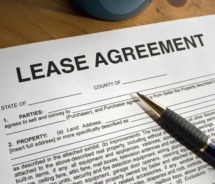 A lease agreement with a pen on top of it