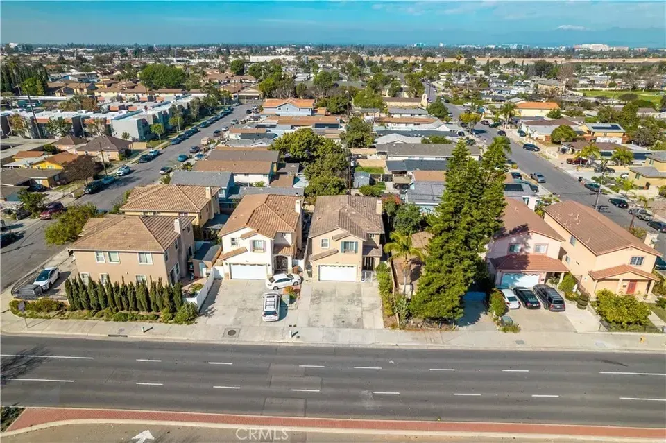 An aerial view of a residential area with a lot of houses and trees.