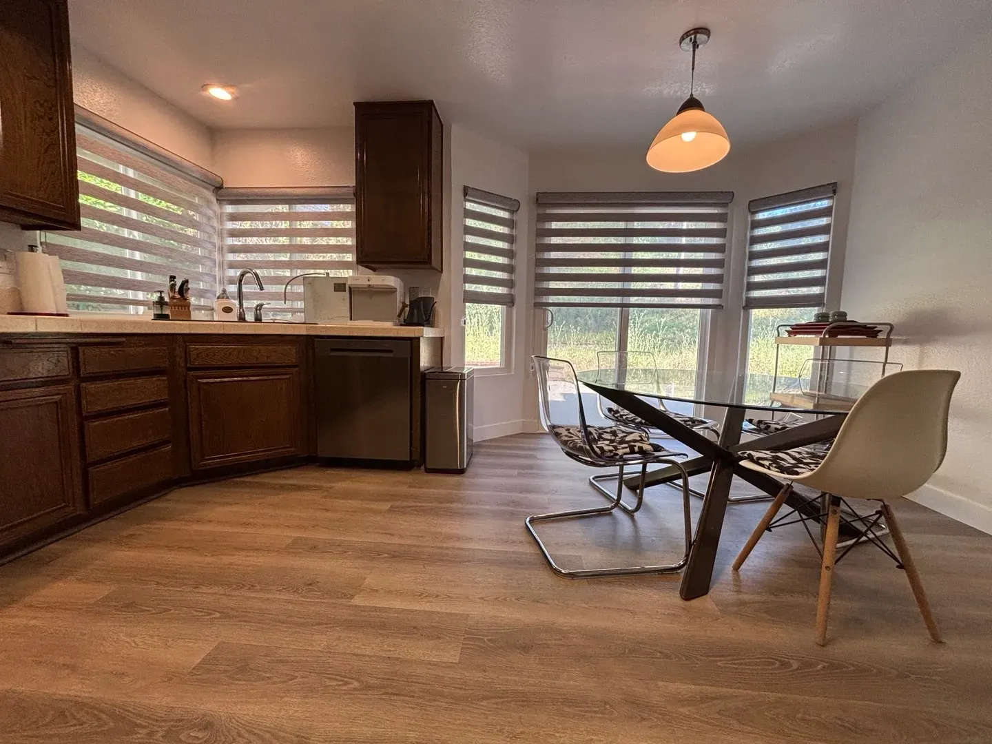 A kitchen with a dining table and chairs in it.