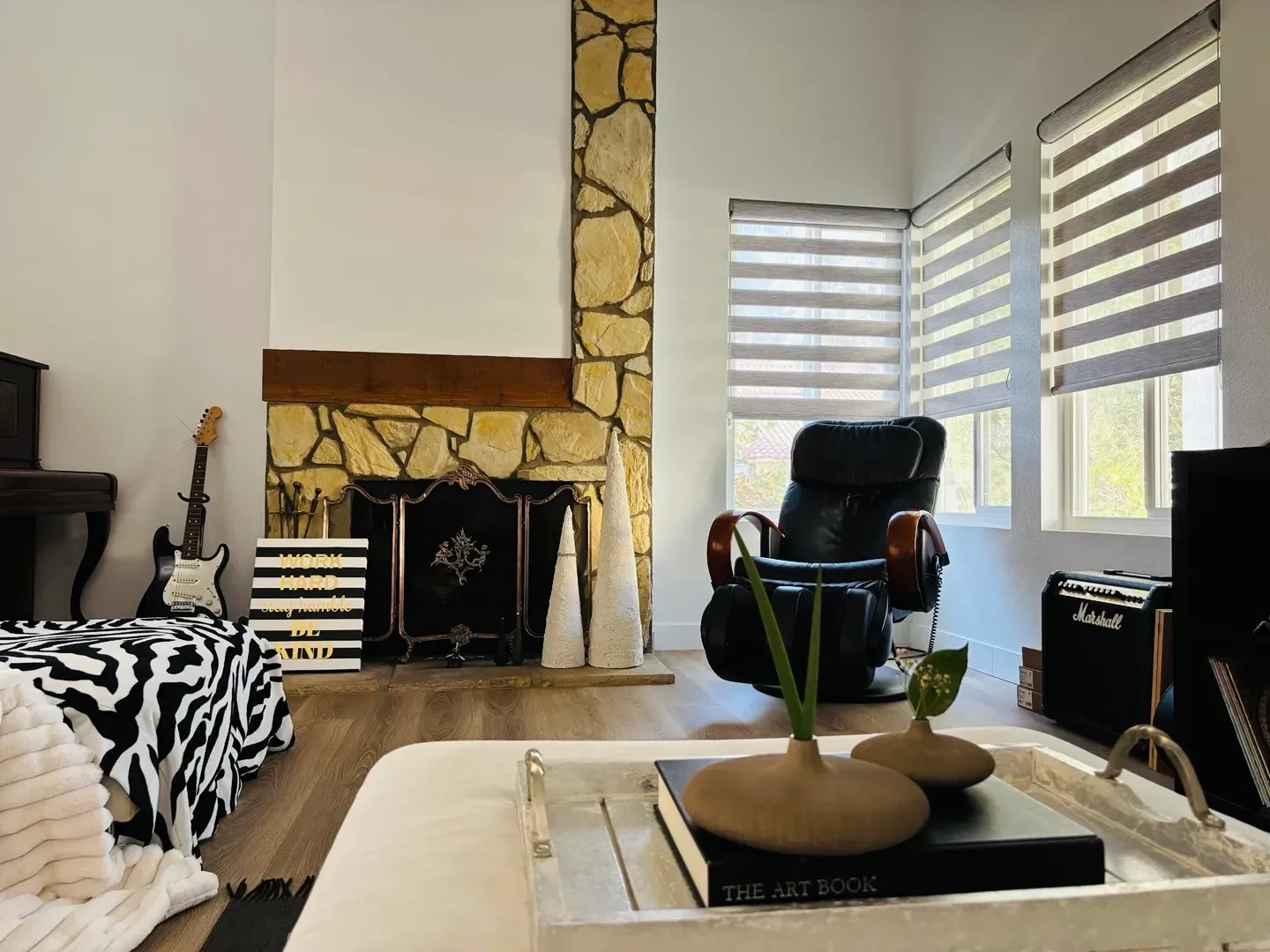 A living room with a fireplace and a chair