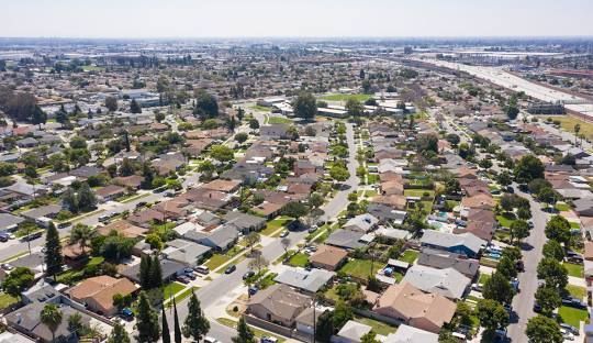 An aerial view of a residential area with lots of houses and trees.