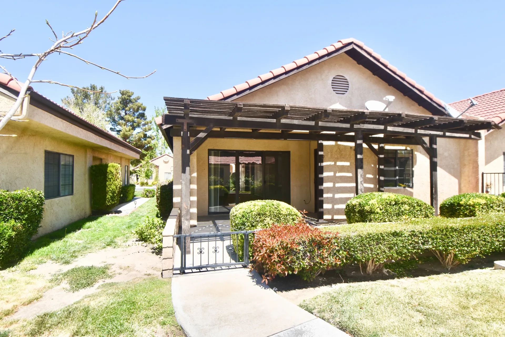 A house with a pergola on the front of it