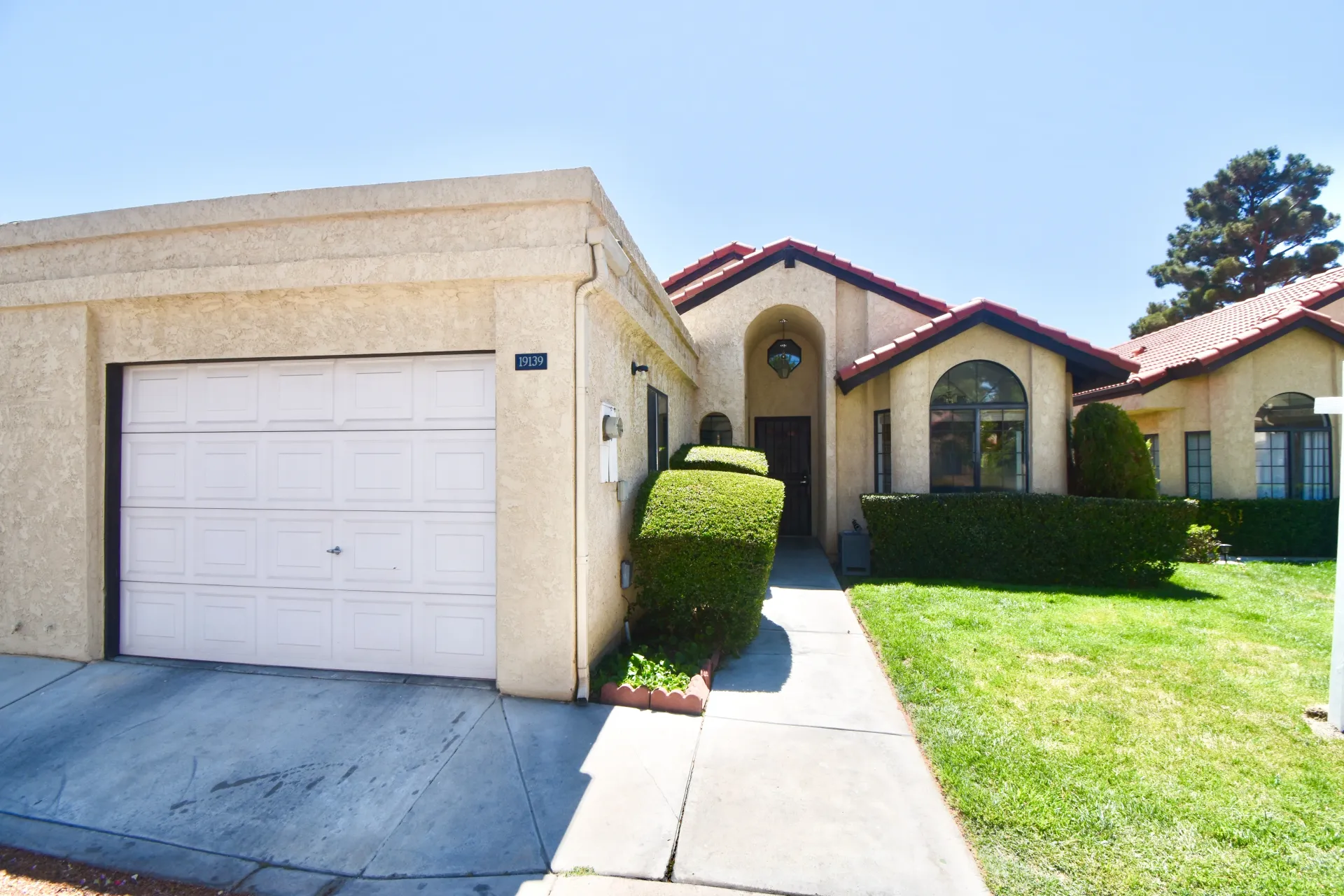 The front of a house with a white garage door