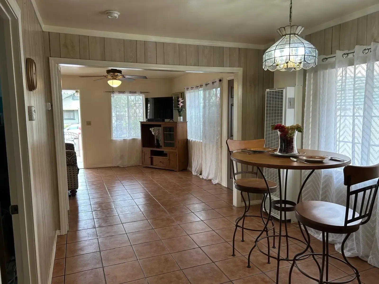 A dining room with a table and chairs in it