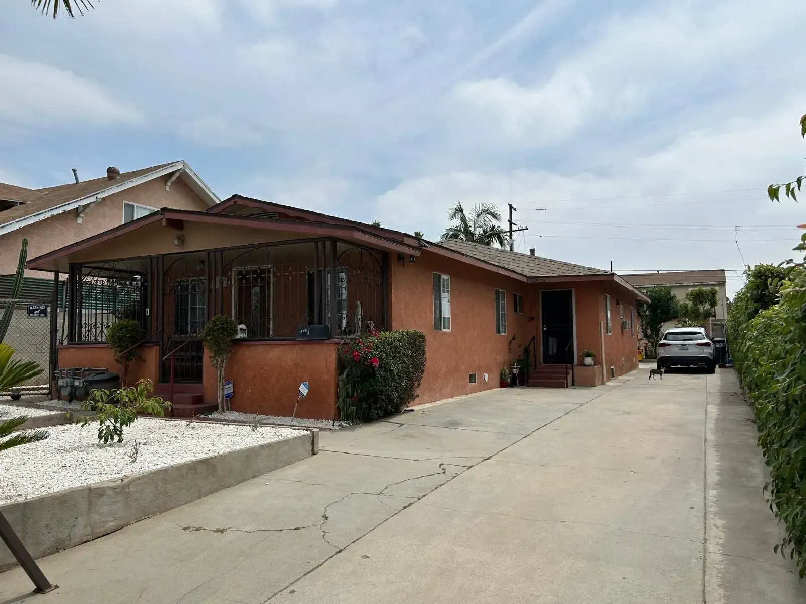A house with a car parked in front of it.
