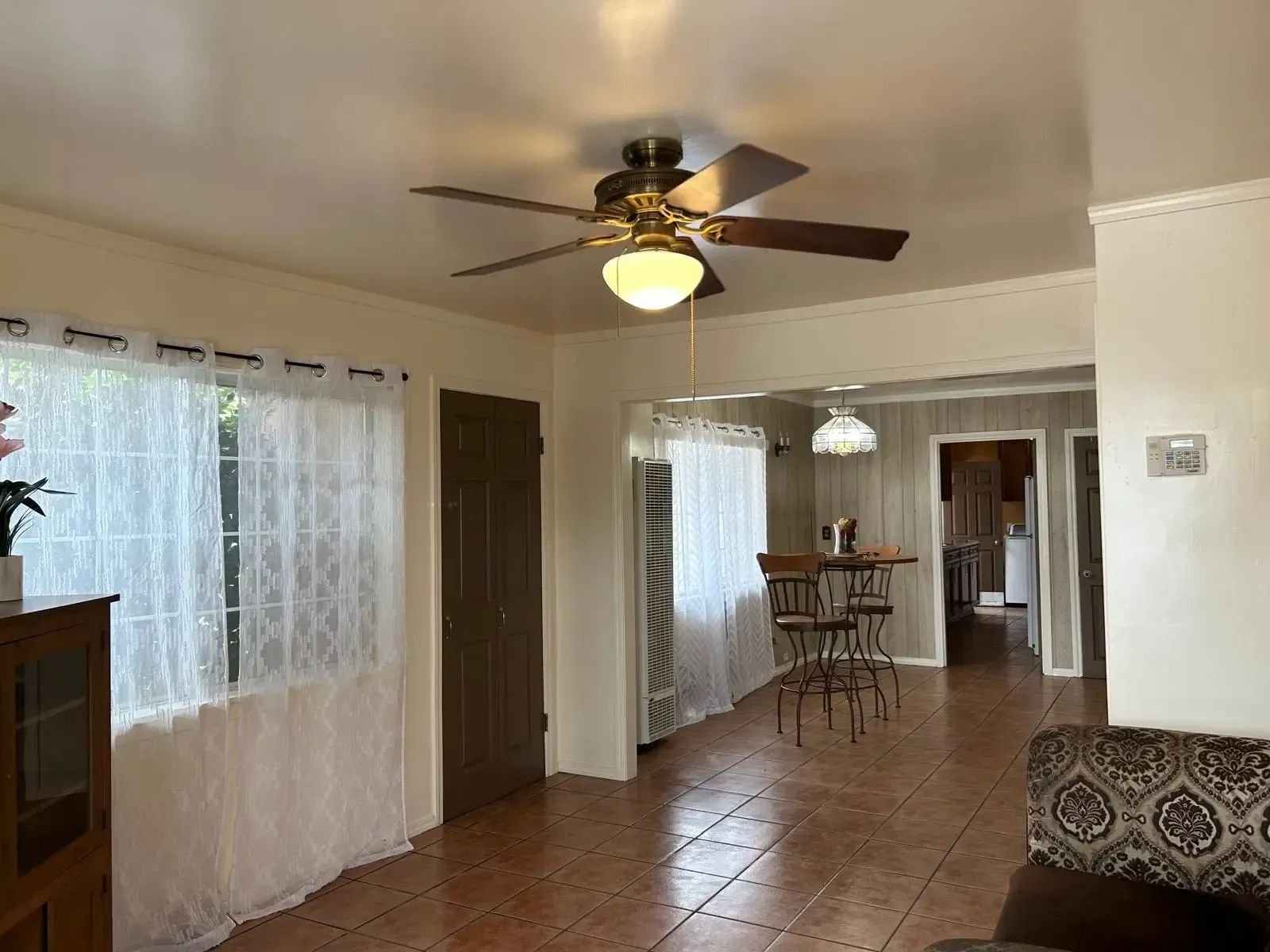 A living room with a ceiling fan and a couch.