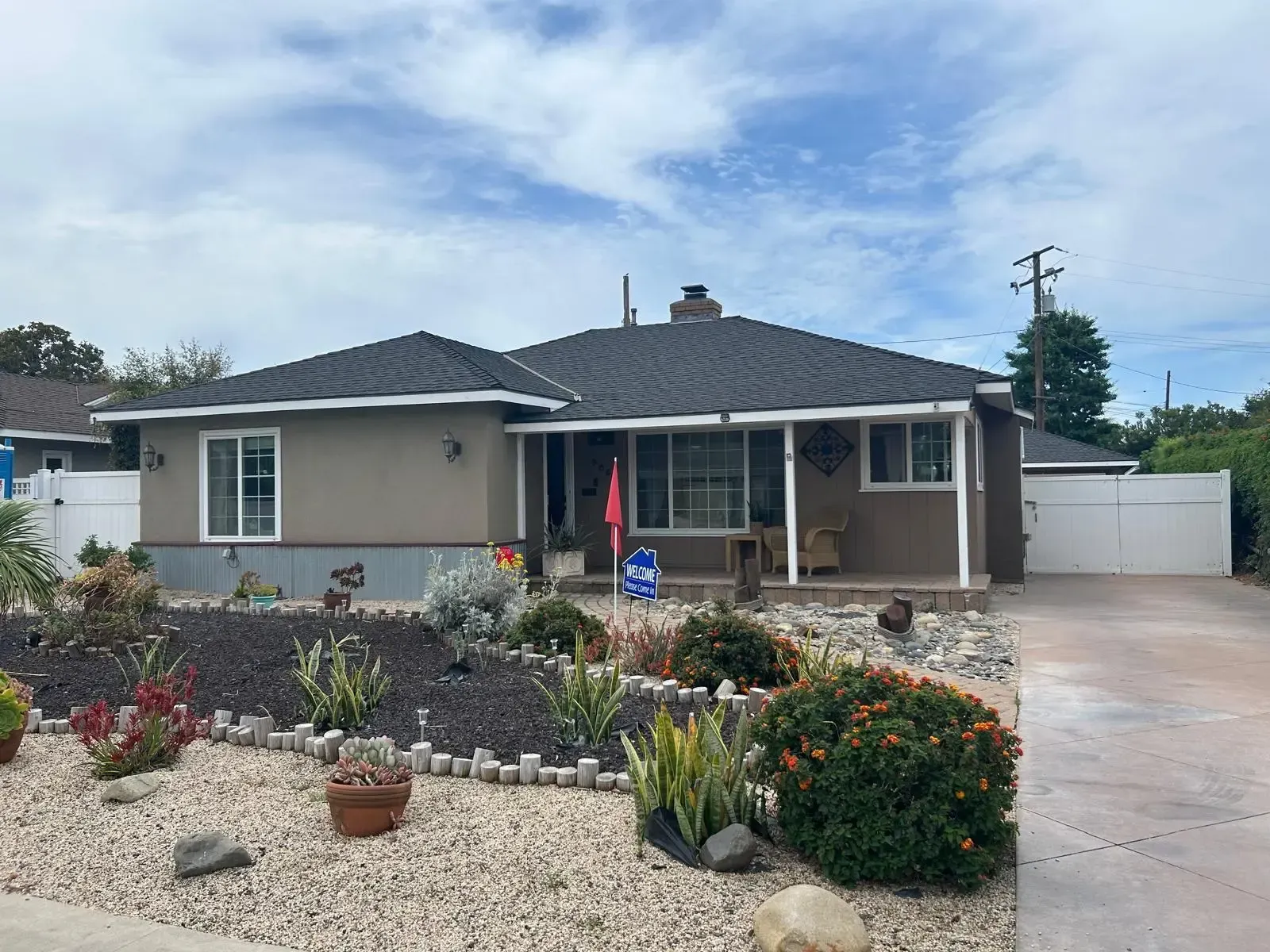 A house with a lot of plants in front of it