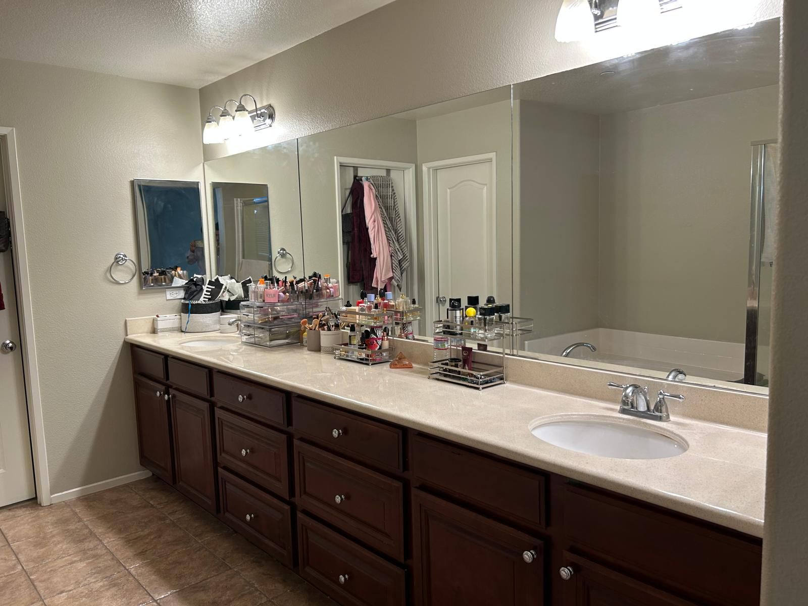 A bathroom with two sinks and two mirrors.