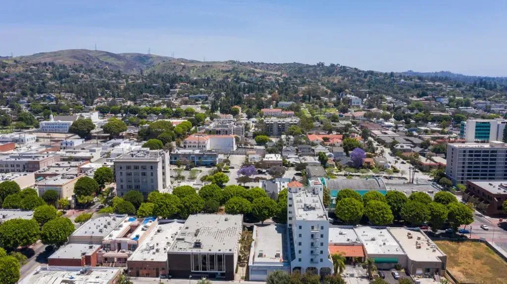 An aerial view of a city with lots of buildings and trees.