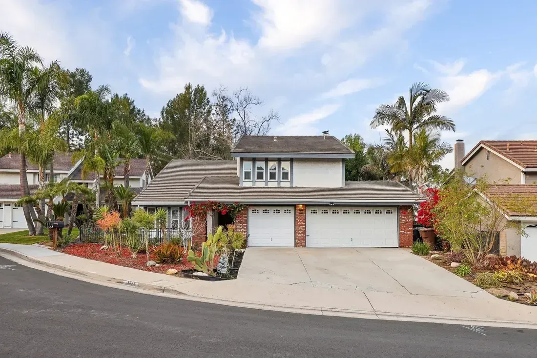 A large house with three garage doors is sitting on top of a hill. anaheim