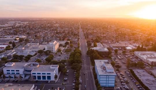 An aerial view of a city at sunset.