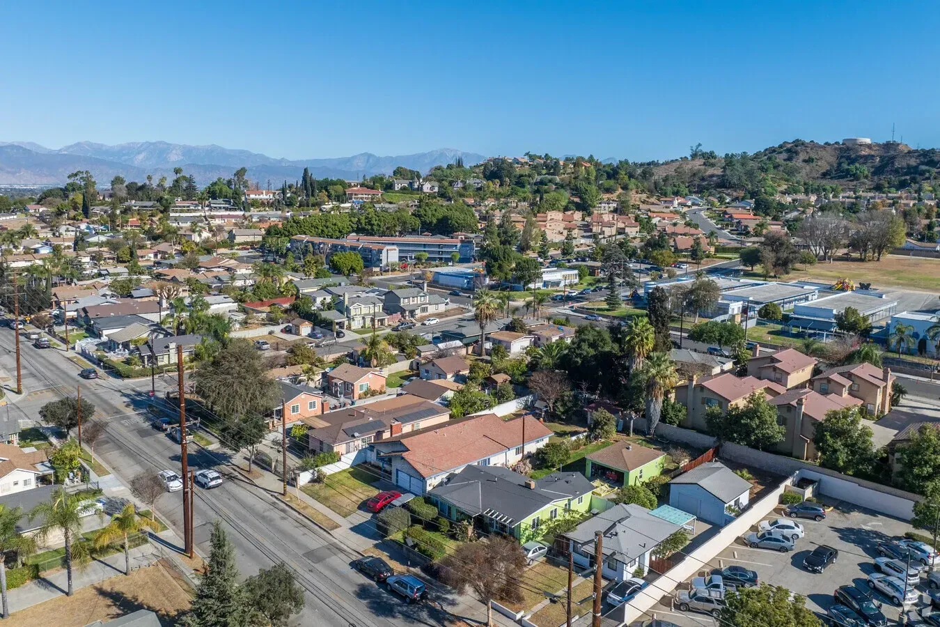 An aerial view of a residential area with mountains in the background. La Puente