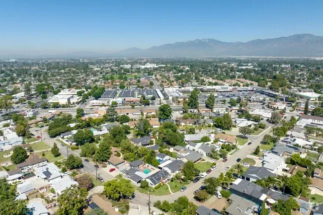 An aerial view of a residential area with mountains in the background.