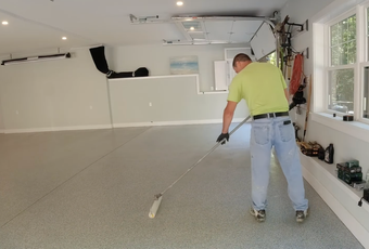 Epoxy flooring contractor applying decorative garage floor coating in Wylie, Texas.
