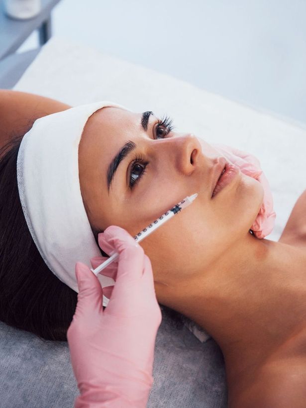 woman getting cosmetic injection treatment