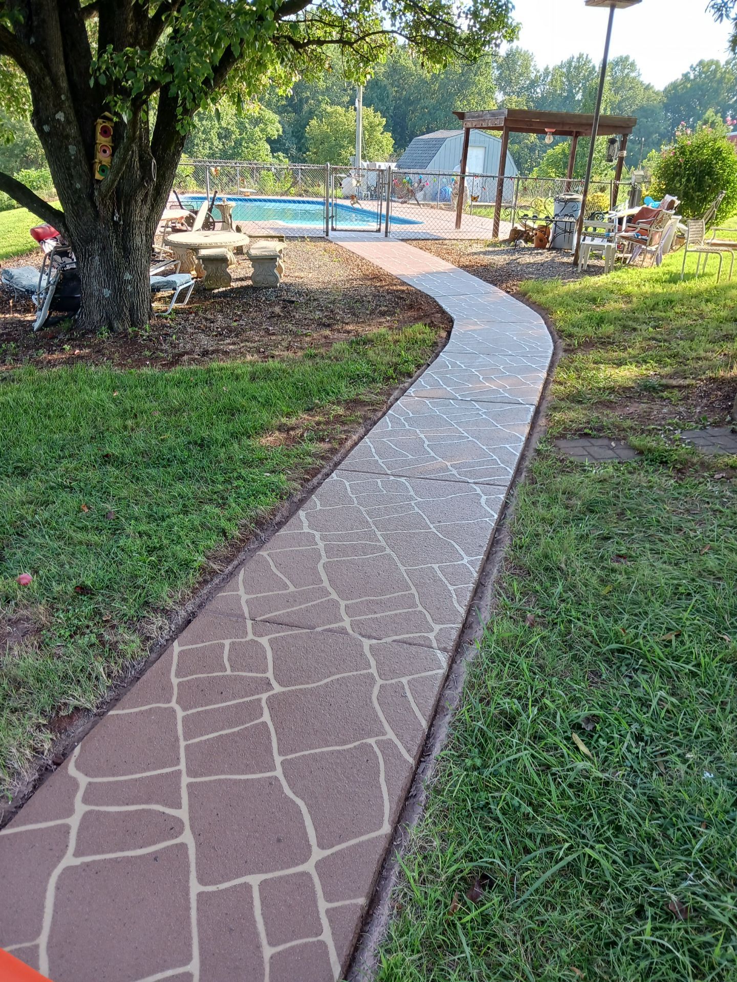 A Walkway Towards A Pool — Kannapolis, NC — Rodriguez Decorative Concrete Coating