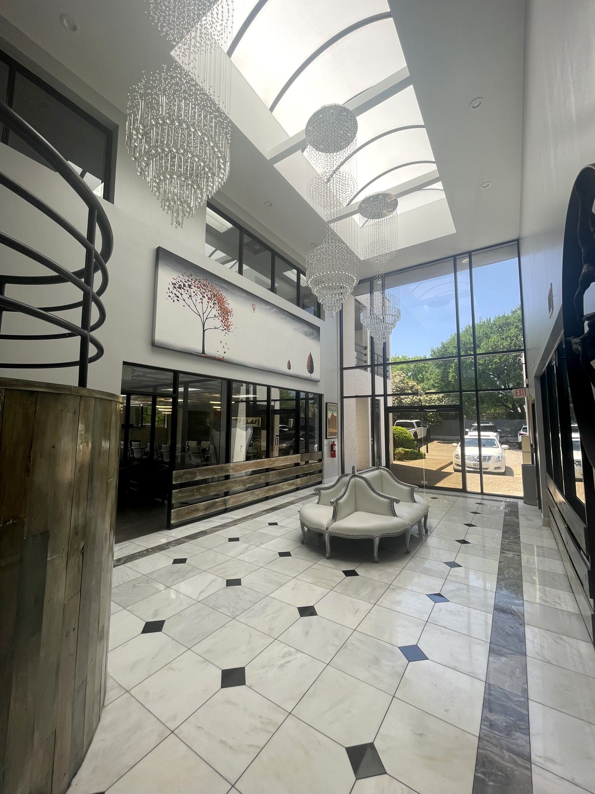 A large lobby with a circular bench in the middle of it.