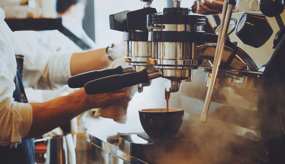 A Barista Uses an Espresso Machine — Premiair Refrigeration, Air Conditioning & Electrical in Armidale, NSW