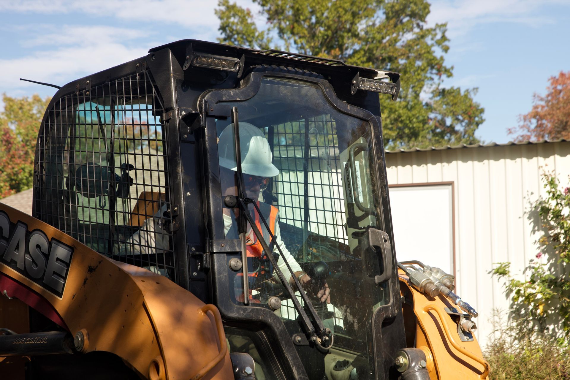 KV Strataworks operator maneuvering a skid steer on-site during an excavation project.