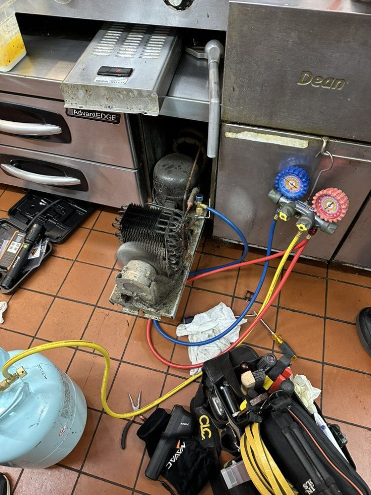 Commercial HVAC repair service with compressor and gauges in restaurant setting