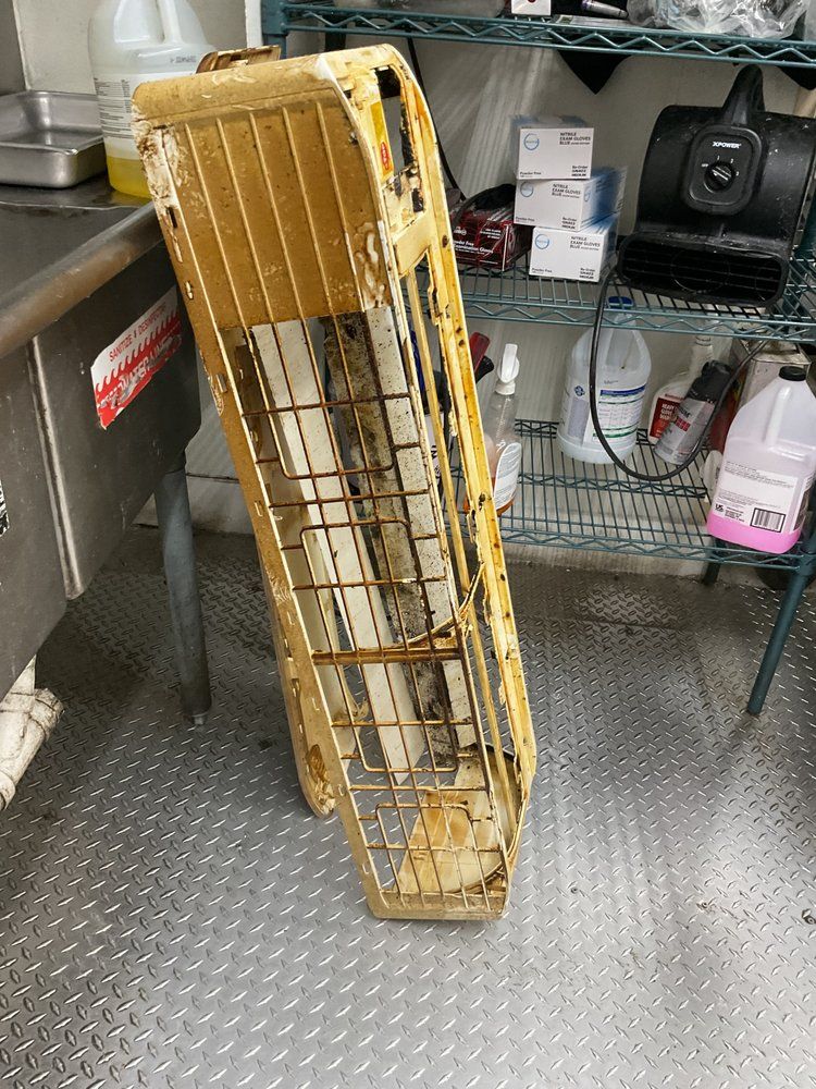 Rusted HVAC grille cover removed during AC maintenance services in Wilmington, NC