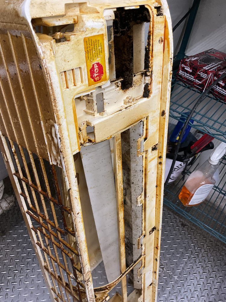 Contaminated indoor AC unit cover removed during HVAC maintenance service near you