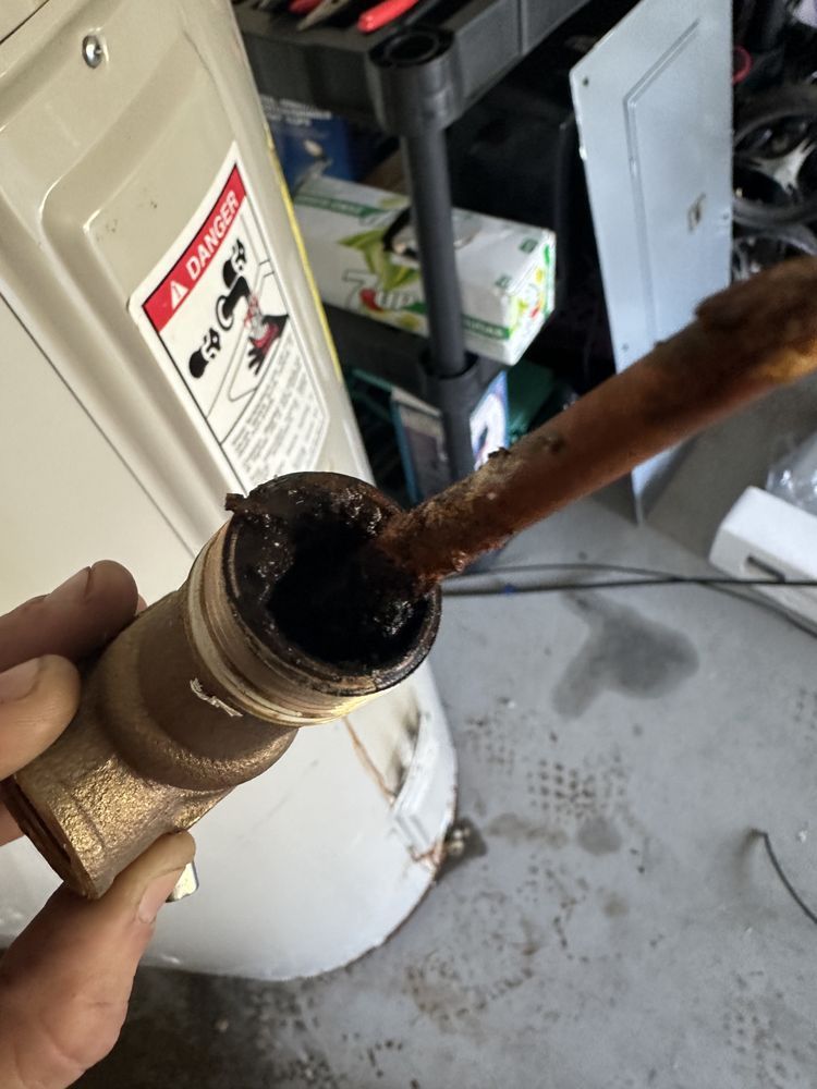 Damaged water heater part showing corrosion during water heater repair service near you